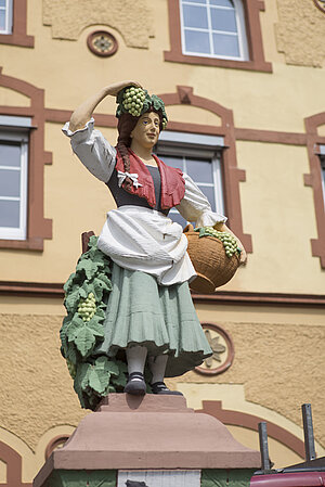 Statue einer Frau, die Trauben trägt